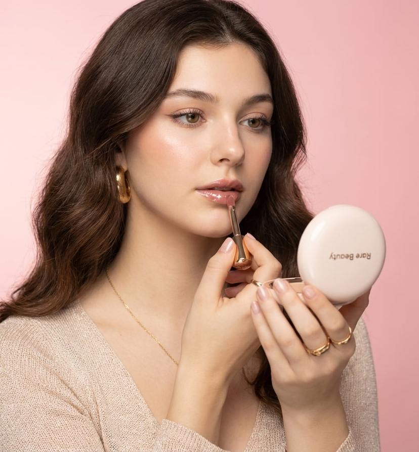 Soft-Toned Makeup Close-Up — Ultra-detailed luxury makeup commercial featuring the uploaded image in a pastel pink studio with soft gradient backdrop fading fro