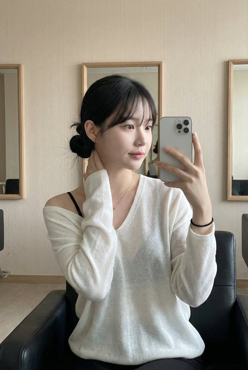 Leather Chair Soft Indoor Mirror Selfie — This photo captures a highly atmospheric indoor Mirror Selfie. It freezes a moment of a young Asian woman in a relaxed