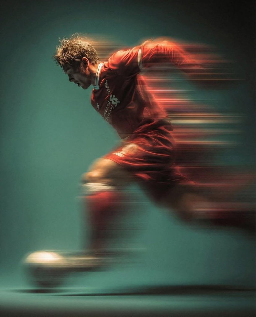 panning-motion-soccer-kick-poster — Panning shot of a mysterious soccer player in red proffesional soccer jearsy mid air kicking a ball, motion blur, cinematic 