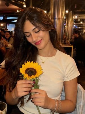 Woman with Sunflower in Warm Restaurant Setting - AI image template preview