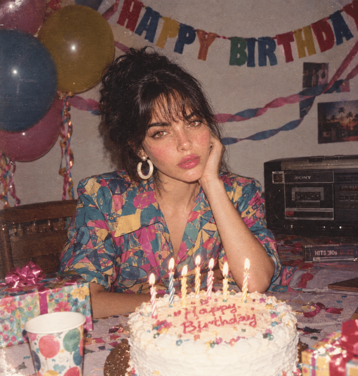 1980s birthday party snapshot with homemade cake, balloons, cassette player and direct flash
