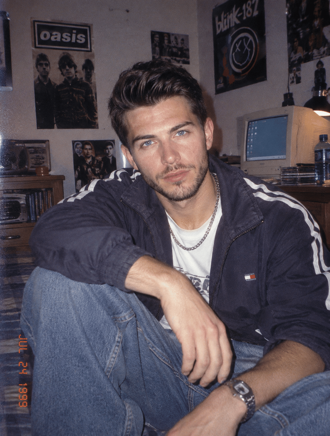 Late-1990s portrait with relaxed denim and restrained metallic accessories, still unmistakably 1999