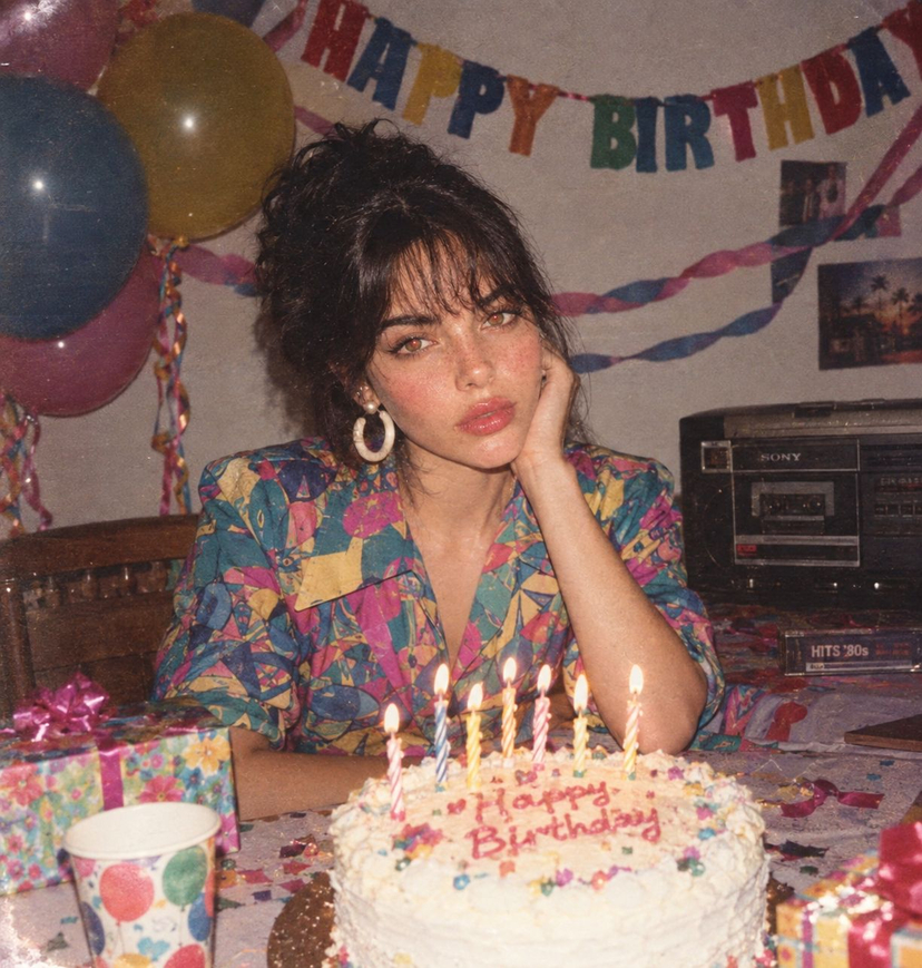 80s Birthday Party — Create a joyful 1980s birthday party photograph featuring the uploaded person. Preserve their exact facial identity. Dress them in authenti