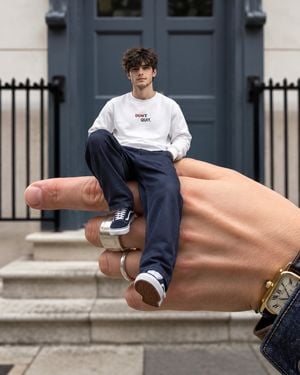 Surreal Miniature Person on Giant Hand preview